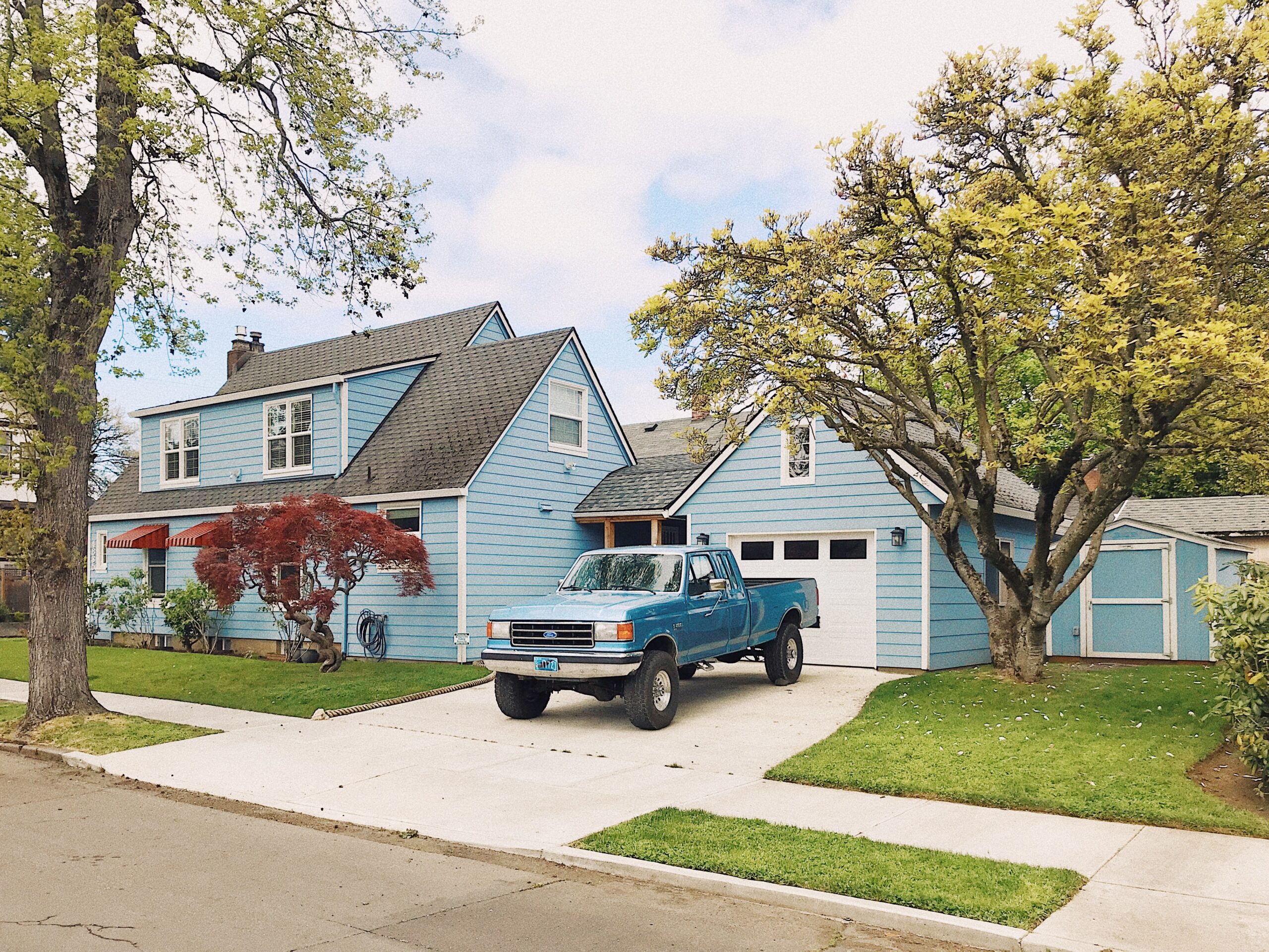 blue California house with blue truck in the driveway